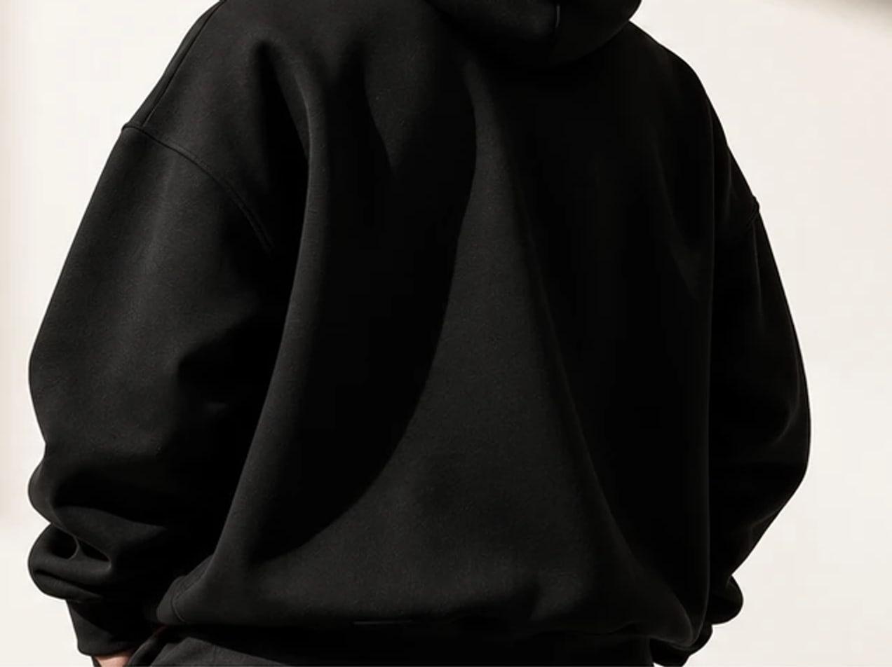 Detail of the black hoodie being worn, seen from behind