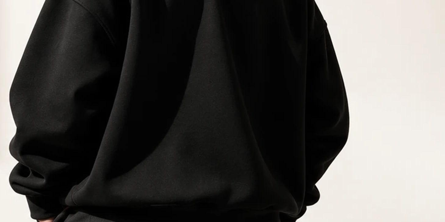 Detail of the black hoodie being worn, seen from behind